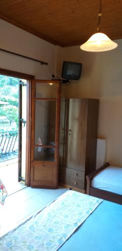 a bedroom with a bed and a sliding glass door at Toulatos Pantelis in Pouláta