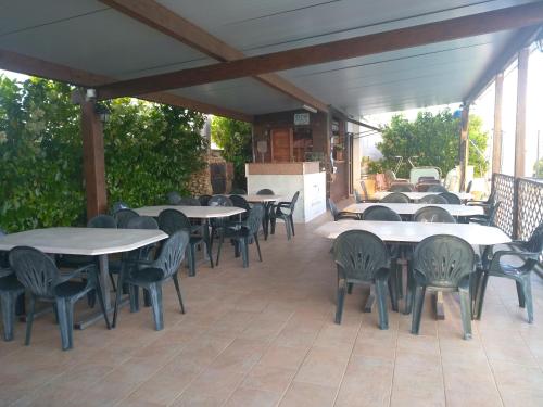 a group of tables and chairs on a patio at B&B Alicino in Cerfignano