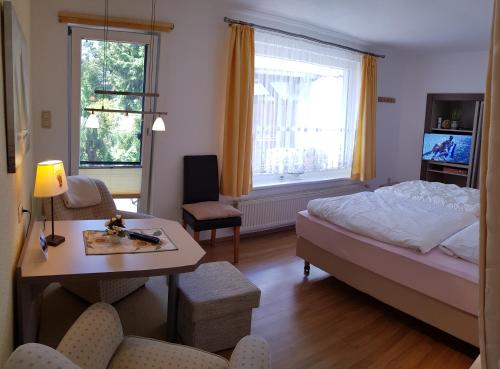 a hotel room with a bed and a table and a desk at Ferienwohnung Graf Strandgut in Ostseebad Karlshagen