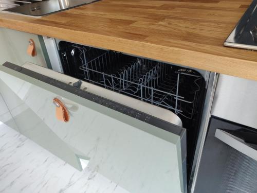 a dishwasher with a dish rack inside of it at Wetterdelle Lodge in Heers