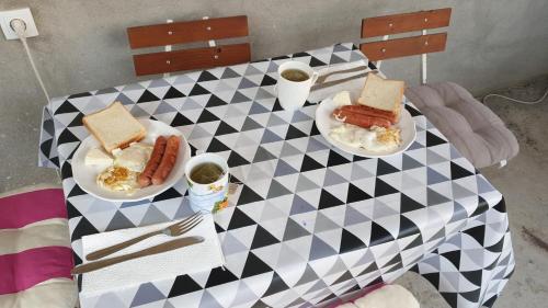 a table with two plates of food and two hot dogs at Sobe Tivat in Tivat