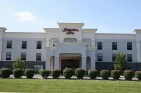a large white building with a lawn in front of it at Hampton Inn LaPorte in LaPorte