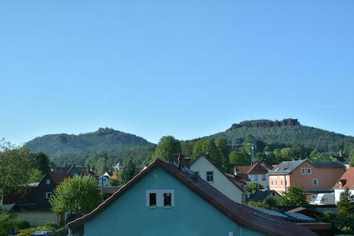 a town with houses and mountains in the background at Ferienwohnung Sonne in Kurort Gohrisch