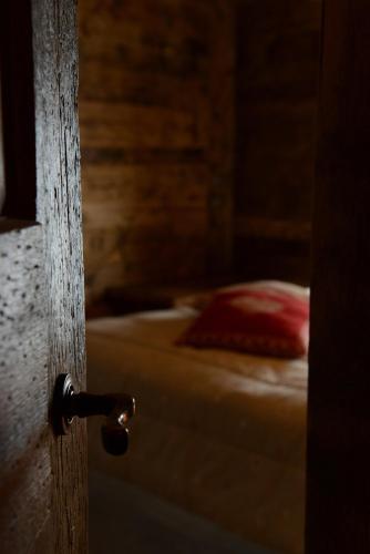 an open door to a bedroom with a bed at Vieilles Maisons D'Introd in Introd