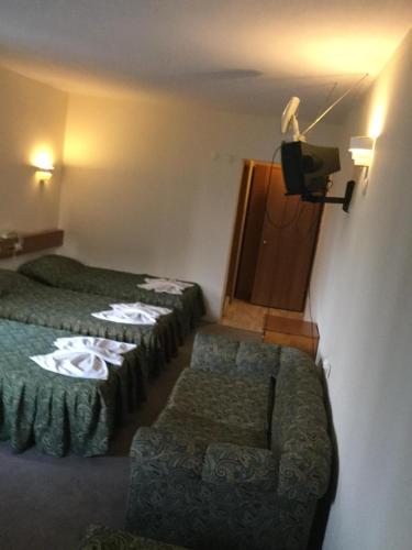 a hotel room with two beds and a couch at Dias Hotel in Kusadası