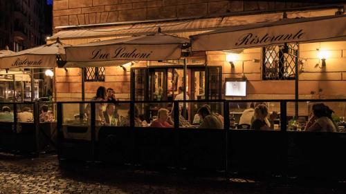 ローマにあるSuite Borghese 42の夜のレストランに座る人々