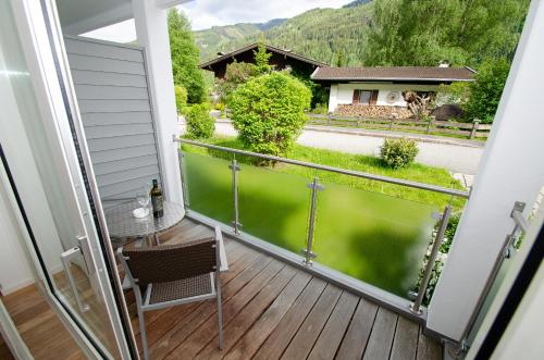 a balcony with a table and a view of a house at Finest Apartments Glacier View by All in One Apartments in Kaprun