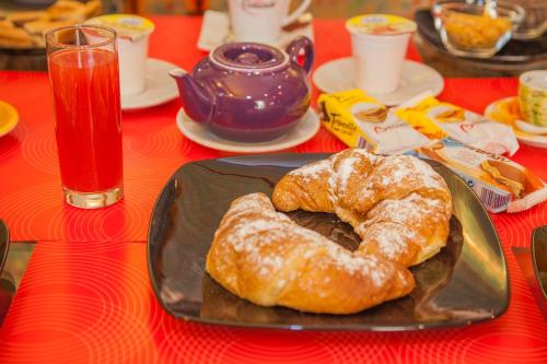 two donuts sitting on a plate on a table at Albergo Della Corte in Benevento
