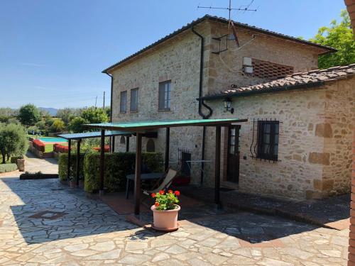 a building with a green awning next to a patio at Agriturismo Casale Giulia in Volterra