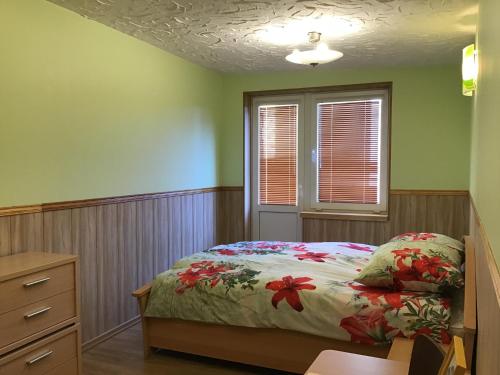 a bedroom with a bed and a dresser and a window at Jaani 2 Apartment in Pärnu