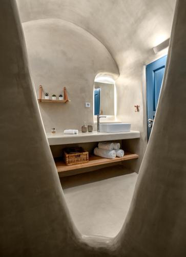 a bathroom with a sink and a mirror at Nalas Suites in Emporio Santorini