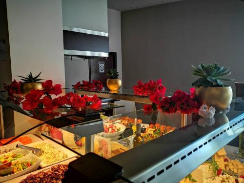 a buffet with many different types of food on display at Long Beach Hotel & Resort in Lóngos