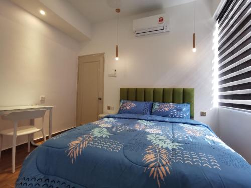 una camera con letto blu e testiera verde di Mahkota2stay a Malacca