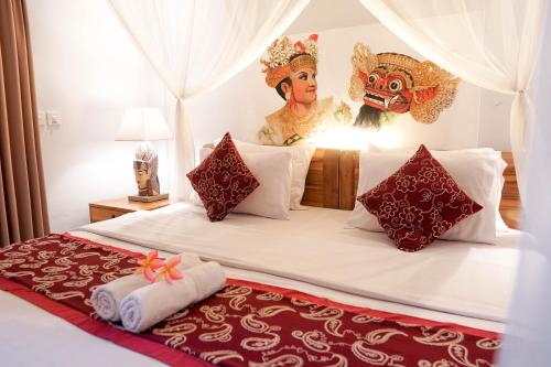 a bedroom with a bed with a mask on it at Budi House Bungalows in Ubud