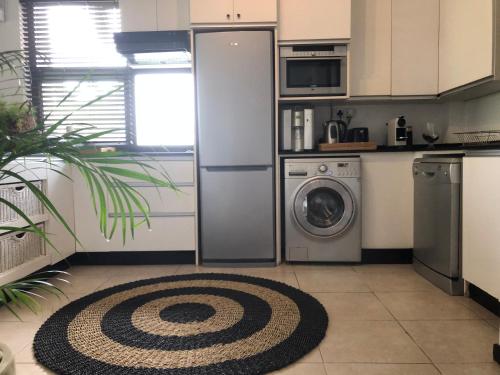 a kitchen with a refrigerator and a washer and dryer at Beach Apartment - Trou aux Biches - Ground Floor in Mont Choisy