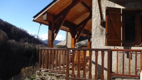 a porch of a house with a wooden balcony at gîte Vallée des Nestes in Bareilles