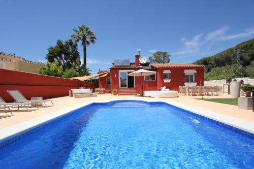 a villa with a swimming pool in front of a house at villa in puerto banus in Marbella