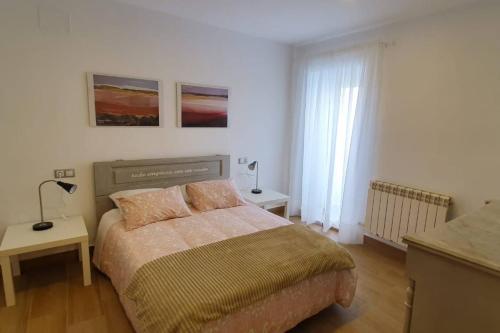 a bedroom with a bed and a table with a lamp at LA GATERA 1D BAJO ARAGON - MATARRAÑA in Fabara
