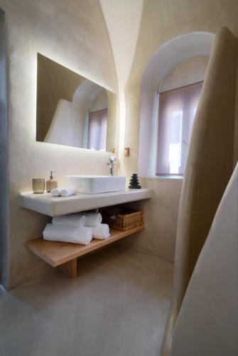 a bathroom with a sink and a mirror at Nalas Suites in Emporio Santorini