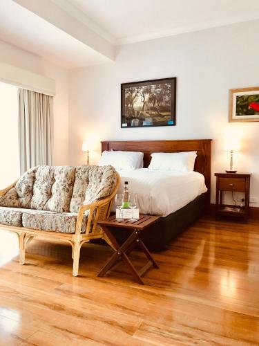 a bedroom with a bed and a couch and a table at Birdwood Motel in Birdwood