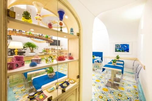 Habitación con ventana y estanterías con plantas en Hotel Royal Prisco, en Positano