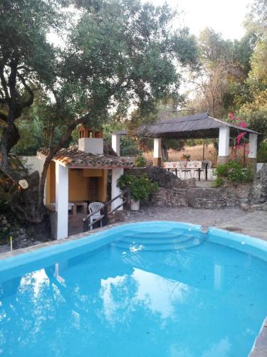 a swimming pool in front of a house at CASA EL CERRO in El Bosque