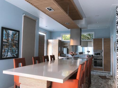 a kitchen with a large white table and chairs at LuxSea Villa in Phan Thiet