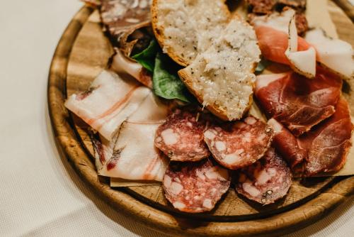 a plate of food with a sandwich and meat at Casa Di Campagna In Toscana in Sovicille