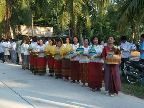 a group of women are lined up in a parade at BeauBo Beach in Baan Tai