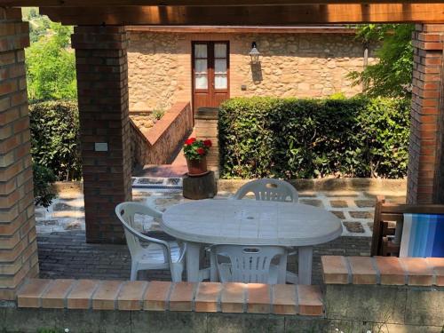 a white table and chairs on a brick patio at Agriturismo Casale Giulia in Volterra