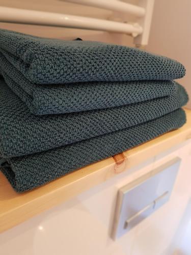 a stack of towels sitting on a wooden shelf at Kotwica Puck in Puck