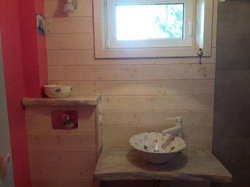 a bathroom with a bowl on a counter with a window at Kaszubskie Marzenie in Kartuzy