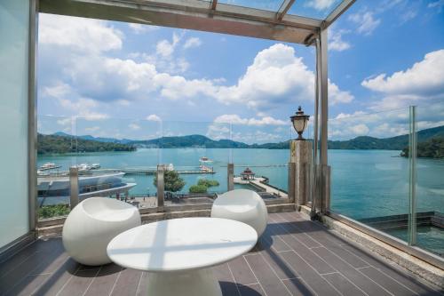a balcony with a view of the water at Shuian Lakeside Hotel in Yuchi