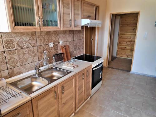 a kitchen with a sink and a stove at Sea Lake Holiday House in Elafonisi