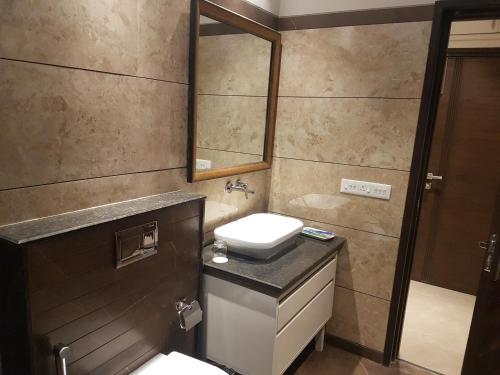 a bathroom with a sink and a mirror at Hotel Kasauli Regency Stags Not Allowed in Kasauli