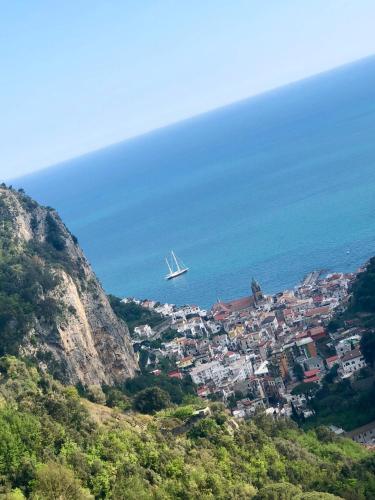 a plane flying over a town on a mountain at Sky House Amalfi Coast in Scala