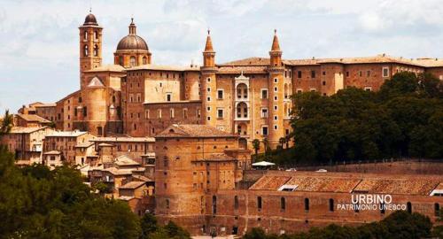 a large brick building with turrets on top of it at La Finestra sul Fiume in Fossombrone