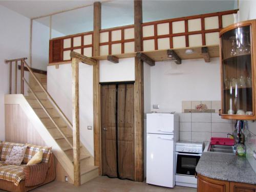 a loft bed in a kitchen with a staircase at Terreno Ro-Bi-Li Ferienwohnung in Cutrofiano