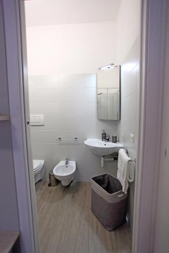 a white bathroom with a sink and a toilet at BB Ombretta in Valeggio sul Mincio