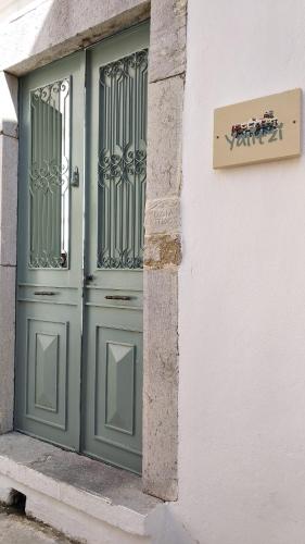 a green door on the side of a building at Yalitzi in Symi
