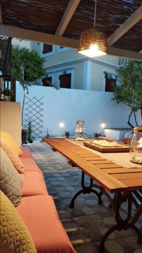 a long wooden table with wine glasses on it at Yalitzi in Symi