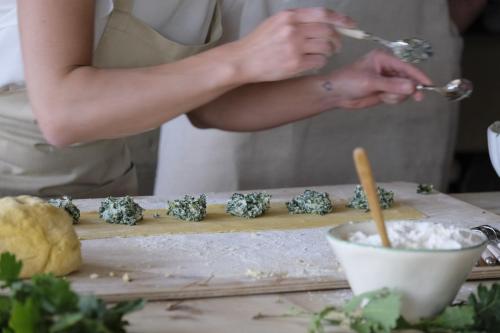 a woman is preparing food on a cutting board at Relais Sant'Elena in Bibbona
