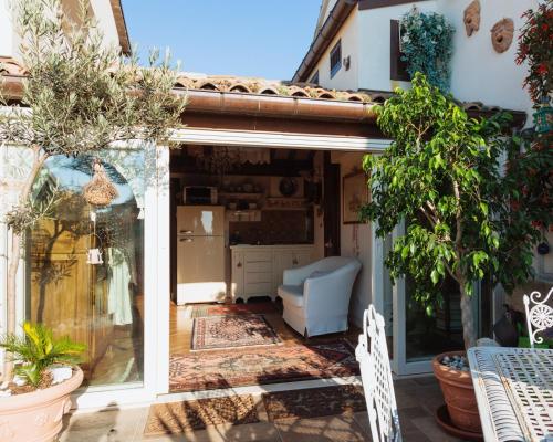 an open door to a patio with a chair and plants at B&B Al Re in Cesena