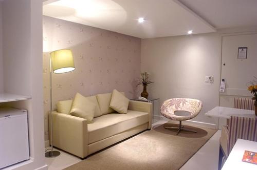 a living room with a couch and a chair at Bahiamar Hotel in Salvador