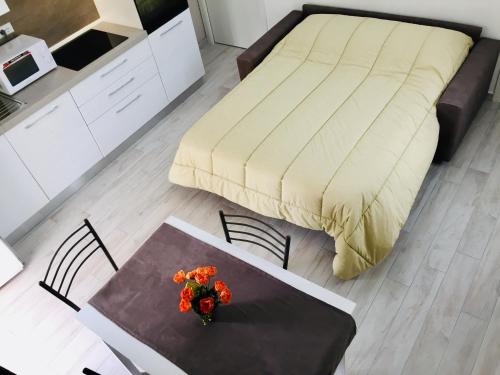 a bedroom with a bed and a table with flowers on it at CASA ALBA in Lucca