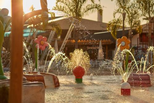 a fountain in a shopping center with fireworks at Boulevard Suíte Hotel by WAM Experience in Caldas Novas