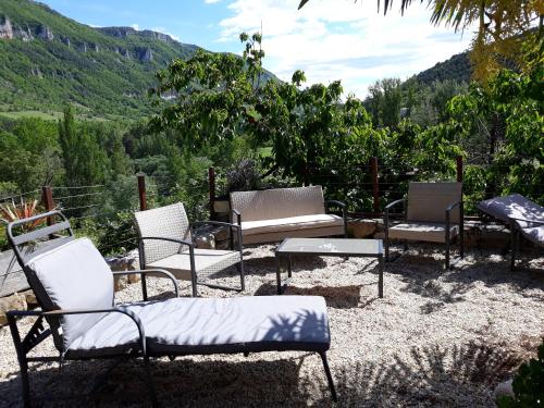 a group of chairs and a table with a view at Le Paillier d'Etienne. in La Cresse
