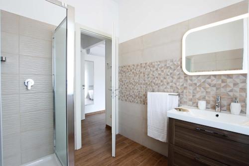 a bathroom with a shower and a sink and a mirror at Affittacamere da Sabri in Numana