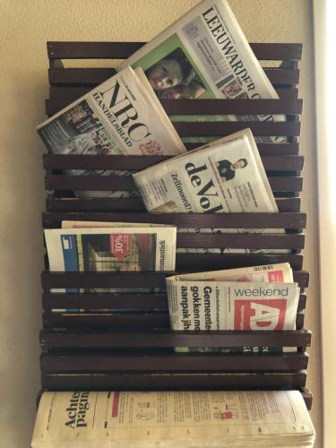 a stack of books stacked on top of each other at Hotel Nap in West-Terschelling