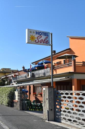 a hotel sale sign in front of a building at Hotel Sole in Marina di Massa